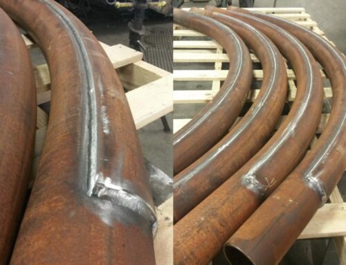Pipe bends with wearpads for abrasion resistance
